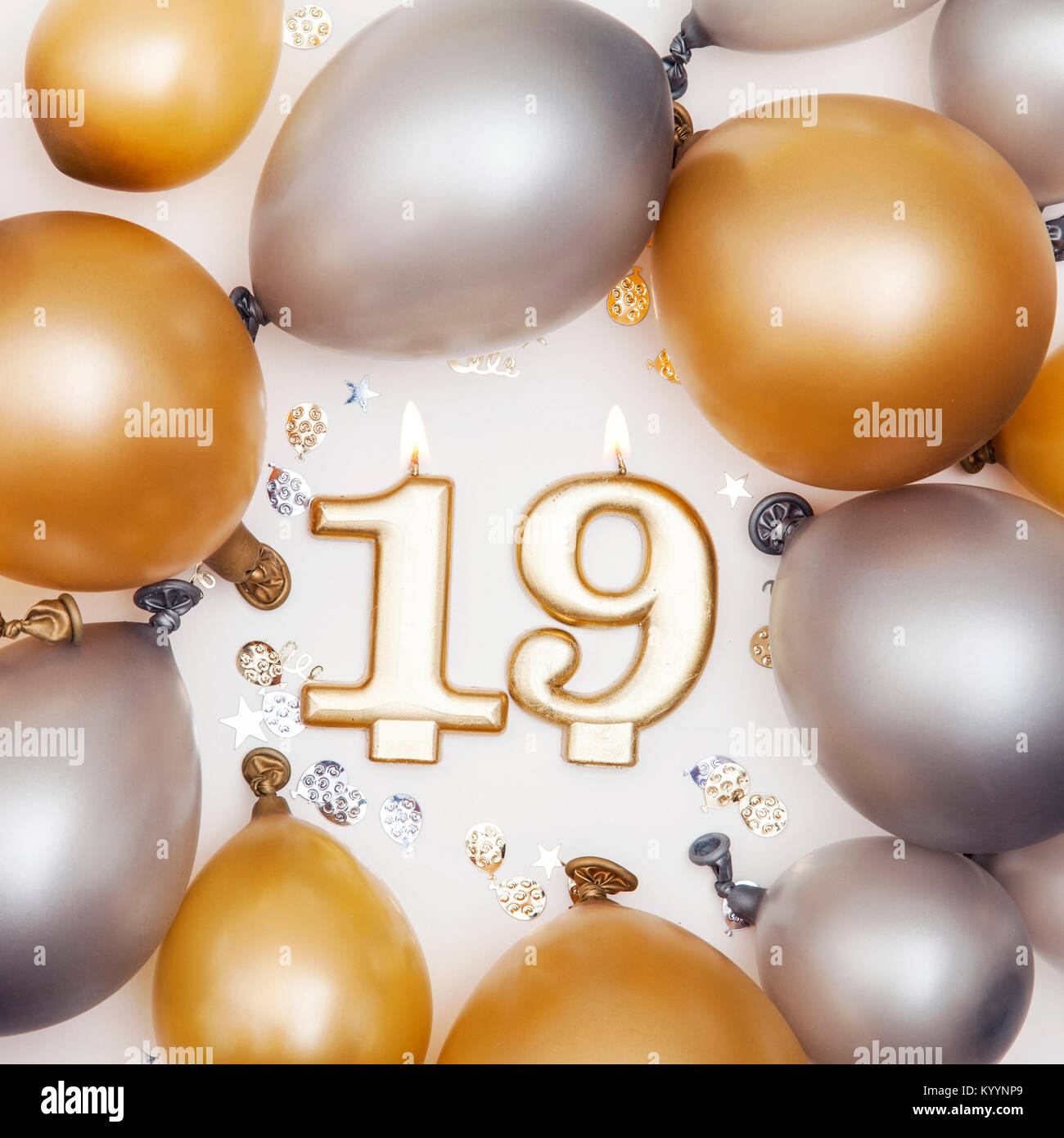 Birthday celebration number 19 candle with gold and silver balloons Stock  Photo - Alamy