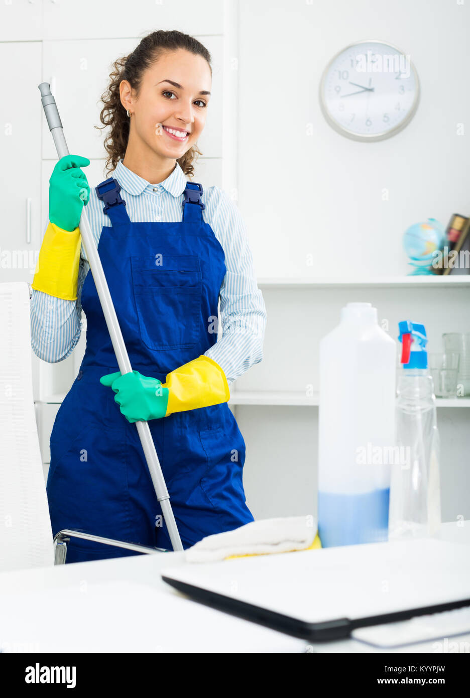 Woman in uniform with supplies cleaning in office Stock Photo - Alamy