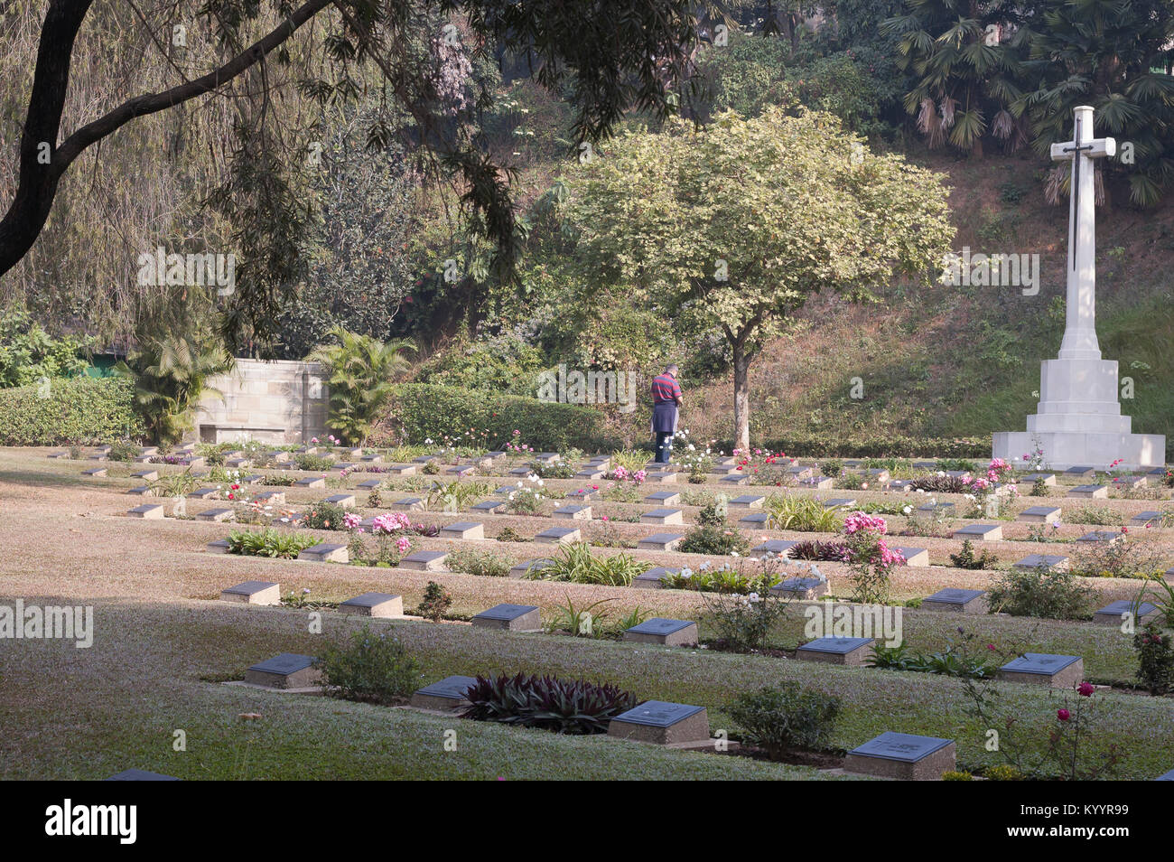 A visitor at the WWII cemetery in Guwahati, India. The war cemetery was set up during WWII for burial of servicemen killed in the war. Stock Photo