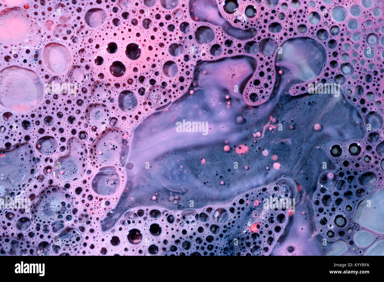 Toxic chemical acrylic oil droplets on water foam creating the idea of