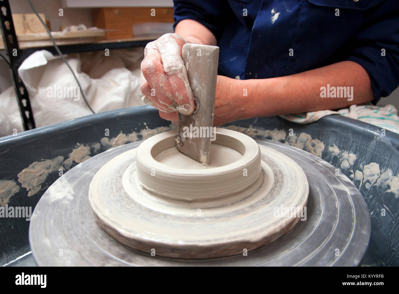 A lady ceramics artist at work in her home pottery studio Stock Photo ...