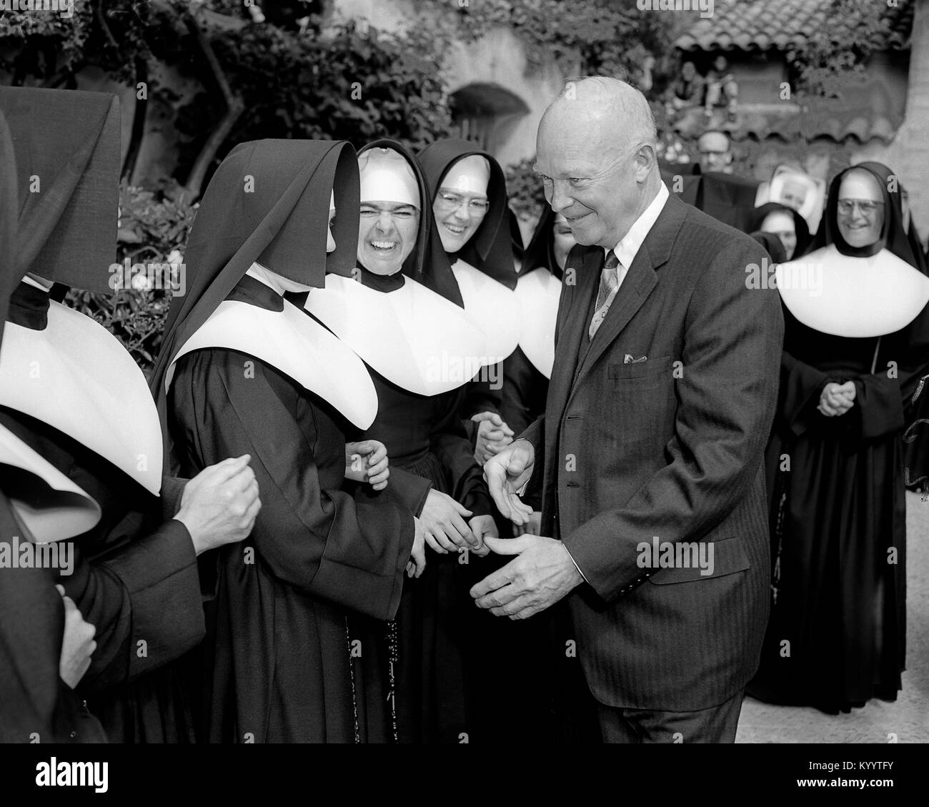 President Dwight Eisenhower shakes hands with nuns at Carmel Mission, California. August 26, 1956 Image from 4x5 inch B&W negative. Stock Photo