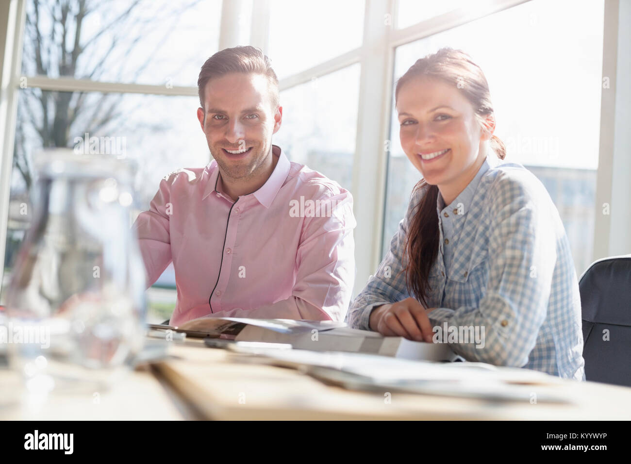 Portrait of smiling young business people in meeting room Stock Photo ...