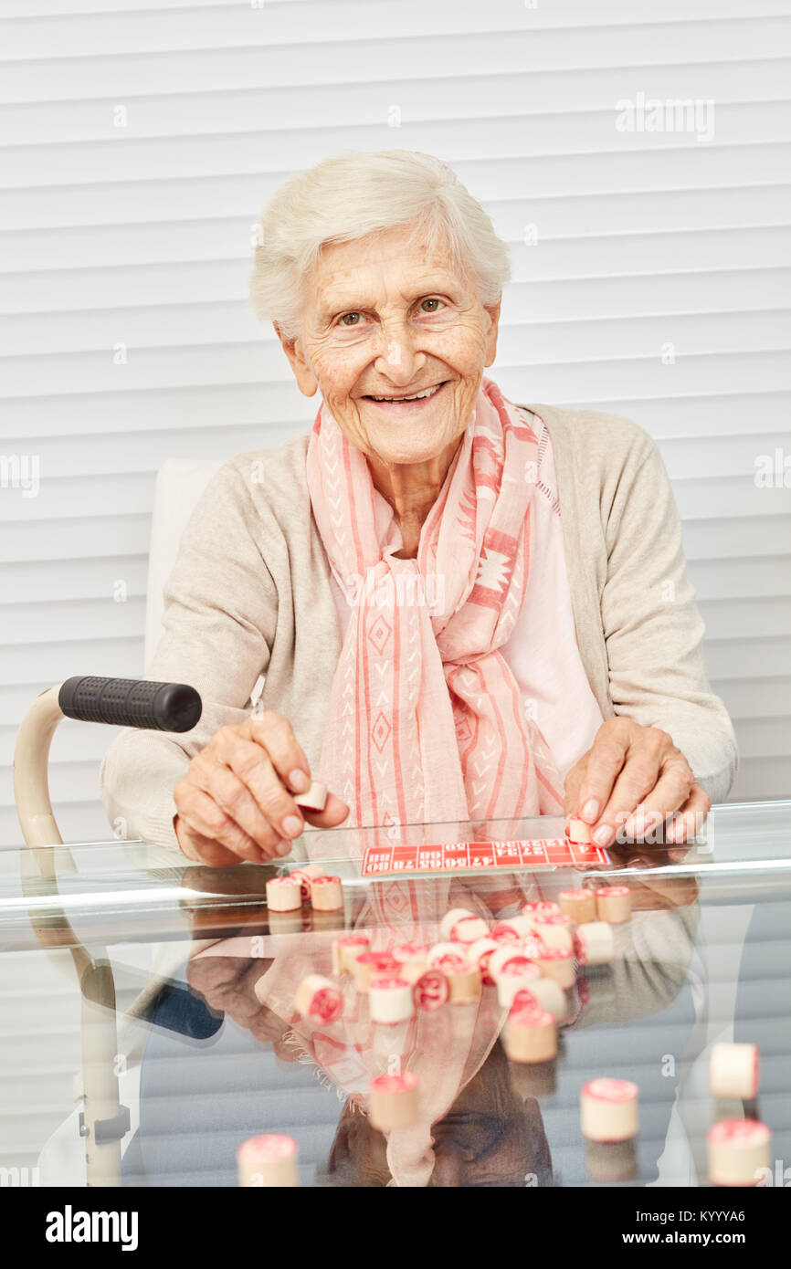 Old senior has fun playing bingo in the afternoon at the retirement home Stock Photo