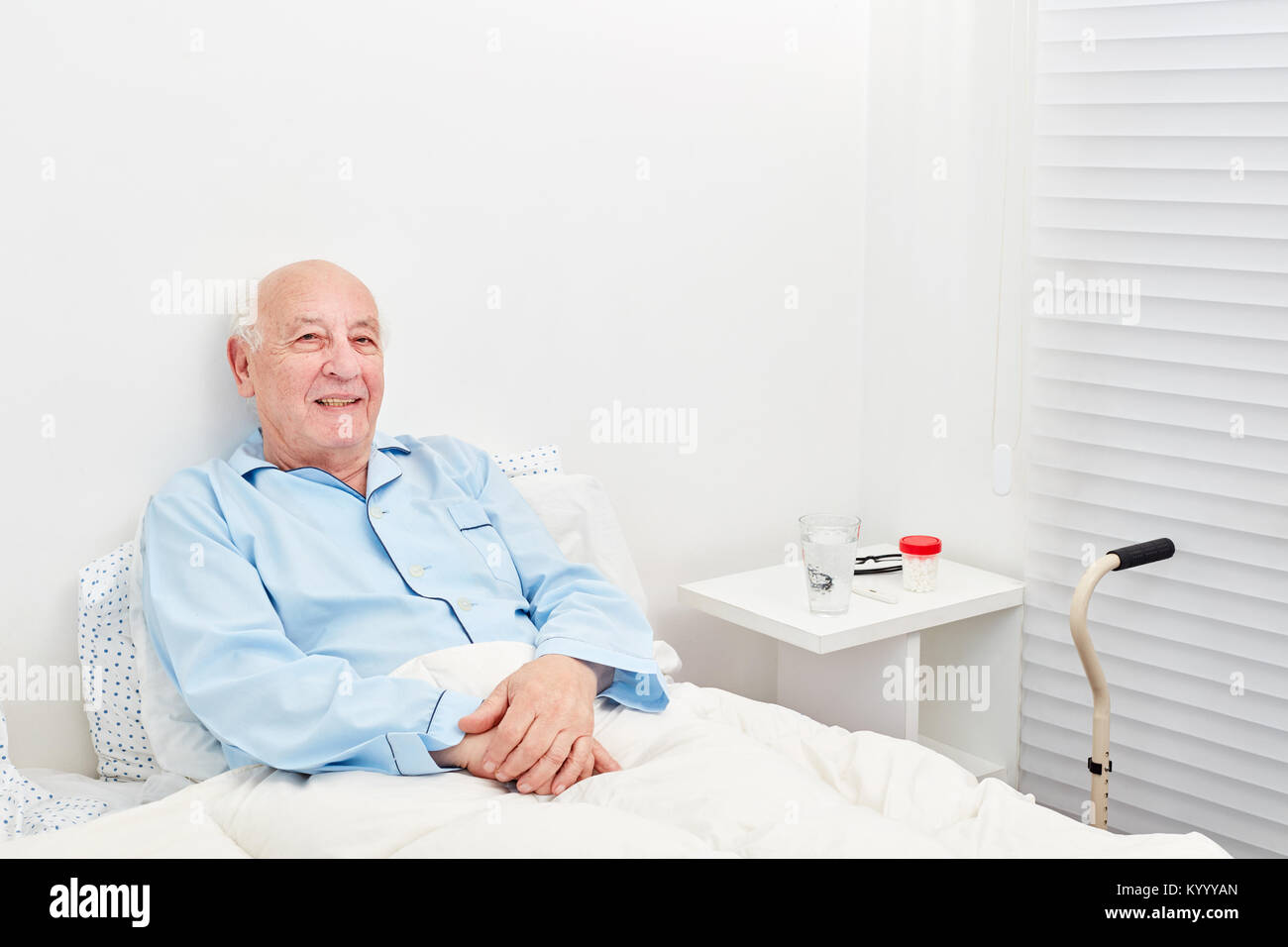 Senior patient is bedridden in bed in hospital or nursing home Stock