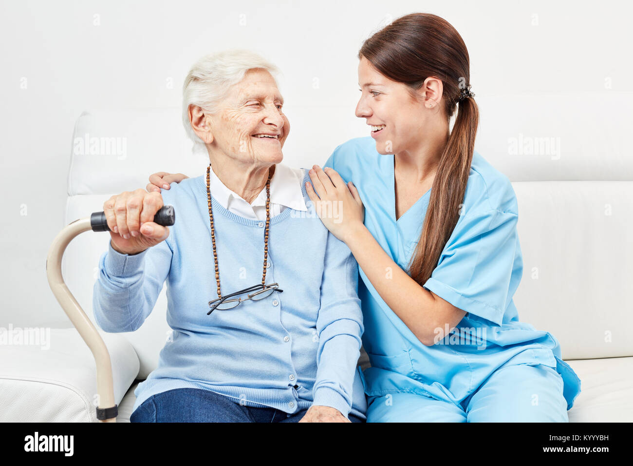Females help with a happy elderly woman home care Stock Photo
