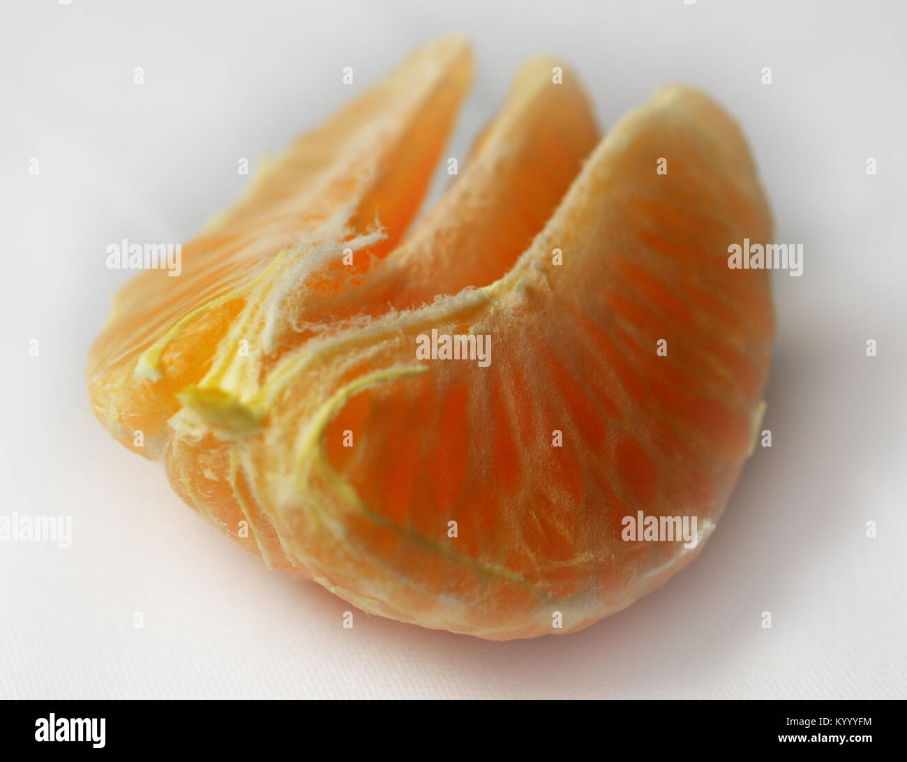 Three Mandarin sections on white background Stock Photo