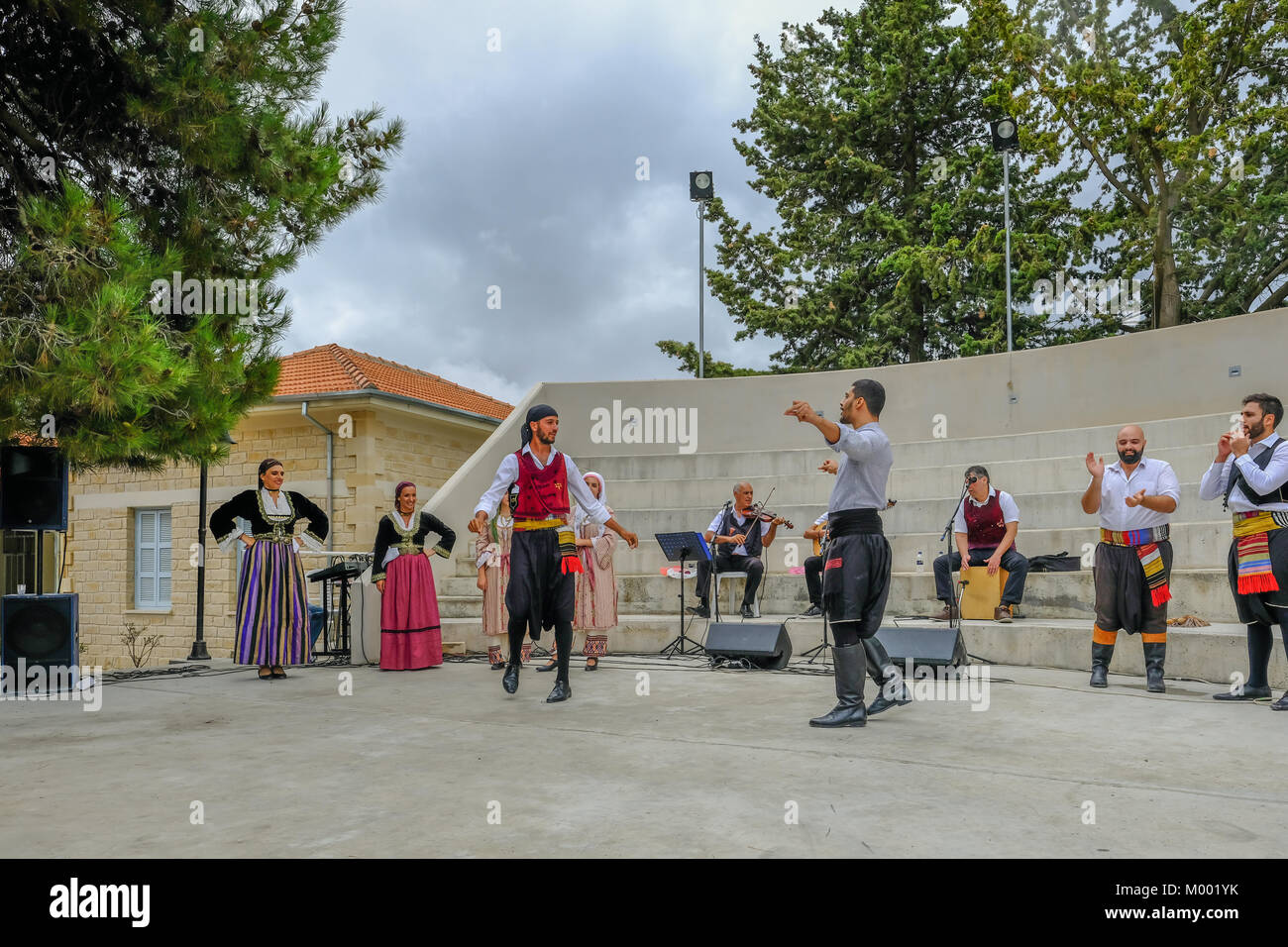 Arsos Village, Cyprus - October 8, 2017: Two men dressed in traditional clothing performing syrtos folk dance at a festival. Stock Photo