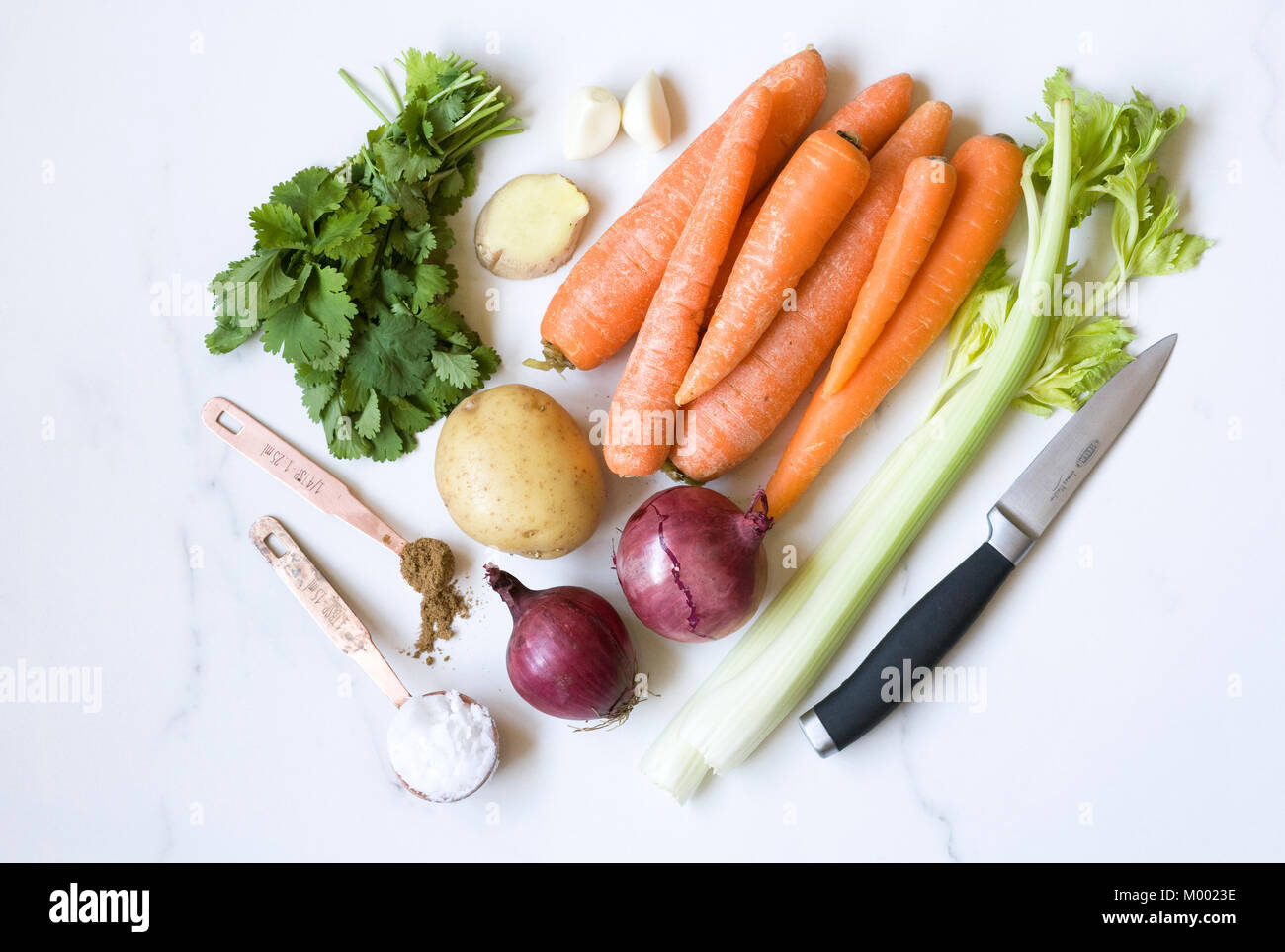 Ingredients for carrot, coriander and ginger soup on a marble background. Stock Photo