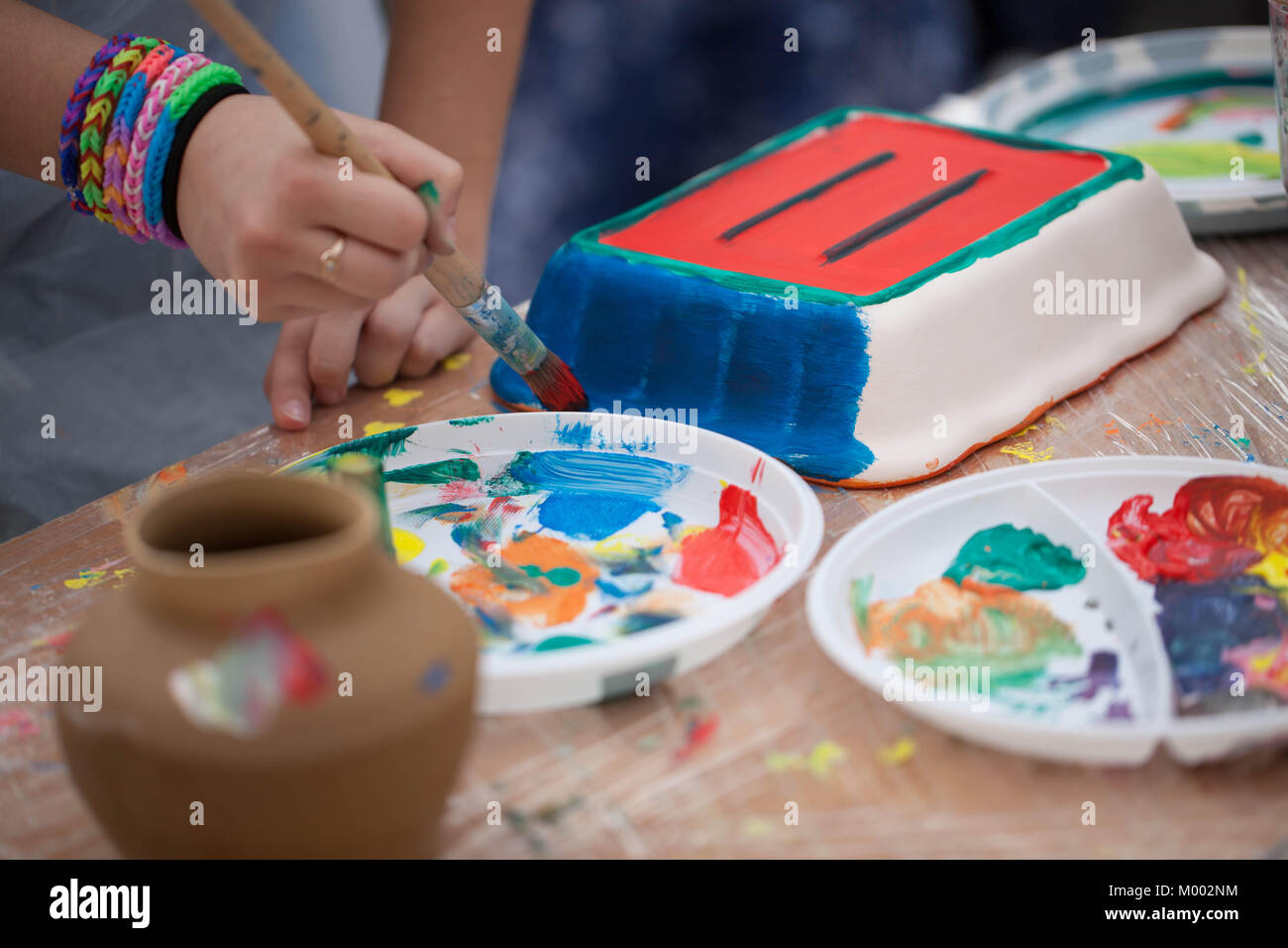 painting ceramics - children painting ceramic dishes Stock Photo