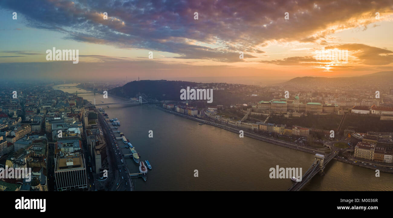 Budapest, Hungary - Panoramic aerial view of Buda Castle Royal Palace, Varkert Bazar, Gellert Hill with Citadella and Statue of Liberty at sunset with Stock Photo