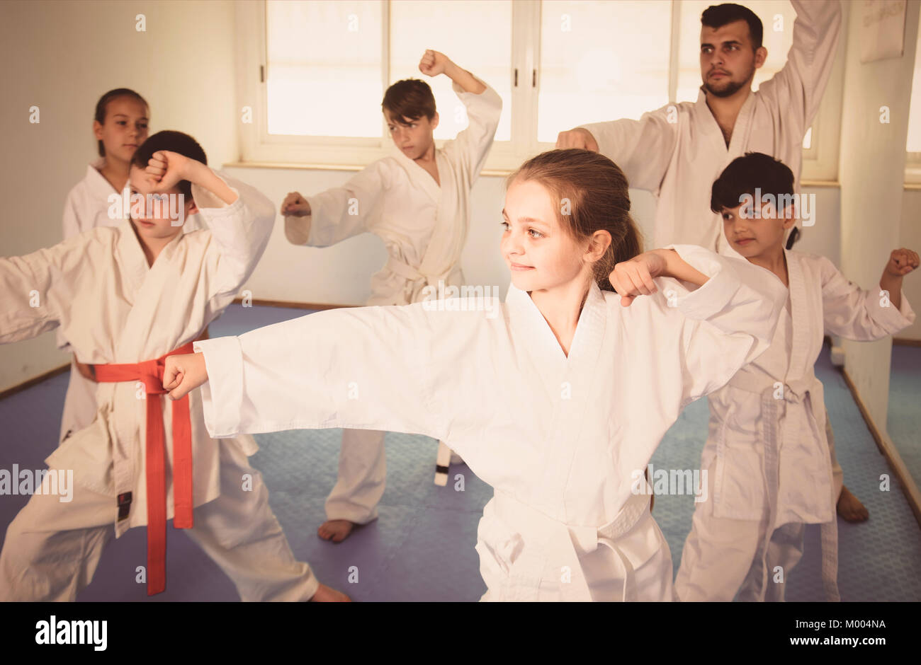 Happy Children Attempting To Master New Moves During Karate Class Stock 