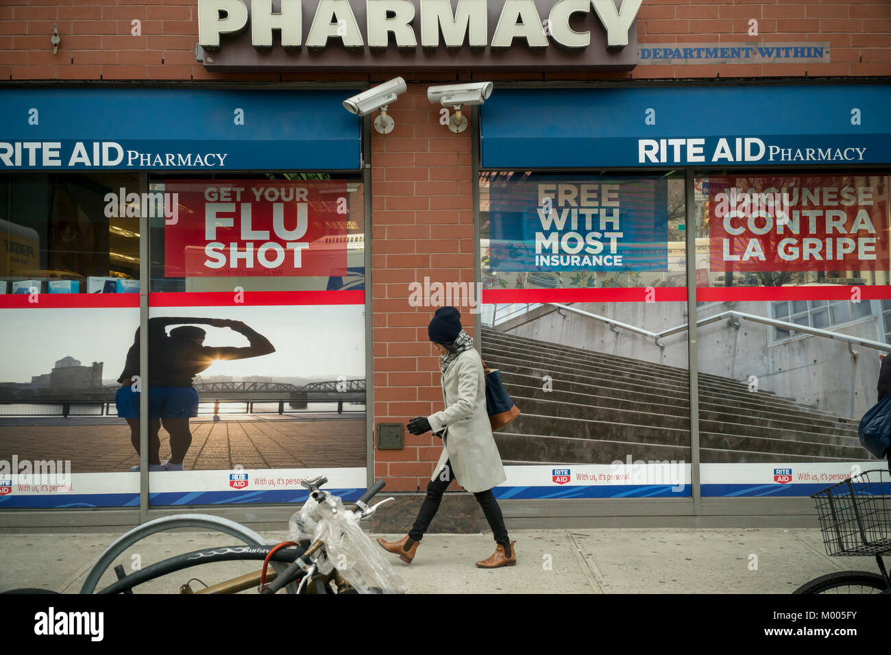 A sign advertises that flu shots are available at a Rite Aid drugstore in New York on Tuesday, January 16, 2018. The Centers for Disease Control and Prevention is reporting that this season's flu activity is widespread across the continental United States for the first time in the 13 years that they have been tracking the spread of the disease. This year's flavor of influenza A is H3N2. (Â© Richard B. Levine) Stock Photo