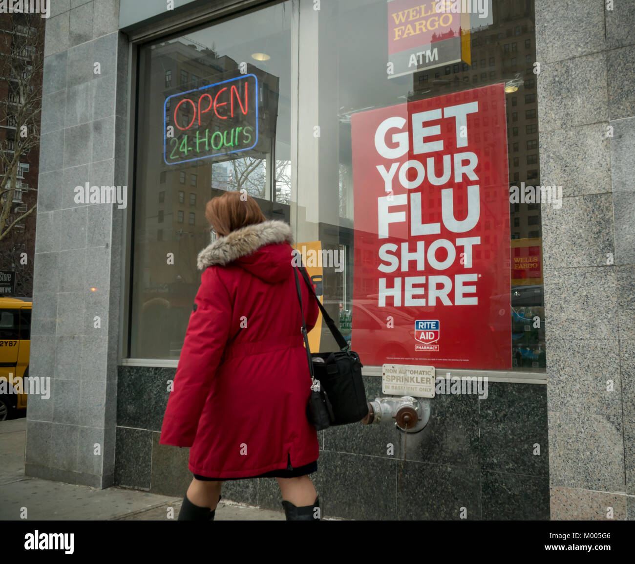 A sign advertises that flu shots are available at a Rite Aid drugstore in New York on Tuesday, January 16, 2018. The Centers for Disease Control and Prevention is reporting that this season's flu activity is widespread across the continental United States for the first time in the 13 years that they have been tracking the spread of the disease. This year's flavor of influenza A is H3N2. (© Richard B. Levine) Stock Photo