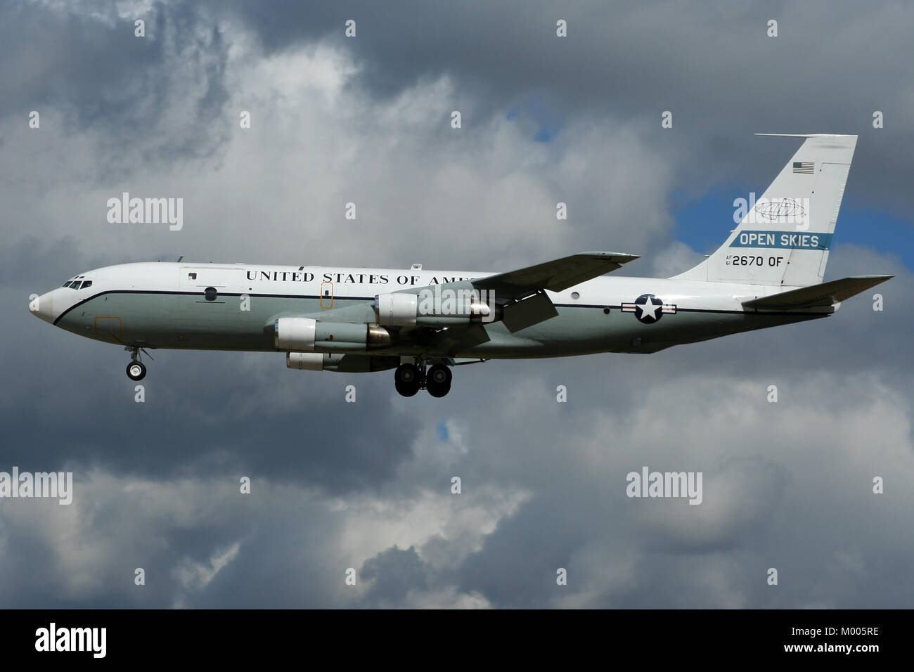Landing in story skies, one of two converted OC-135's operated by the United States Air Force for the Open Skies Treaty arrives at Mildenhall. Stock Photo