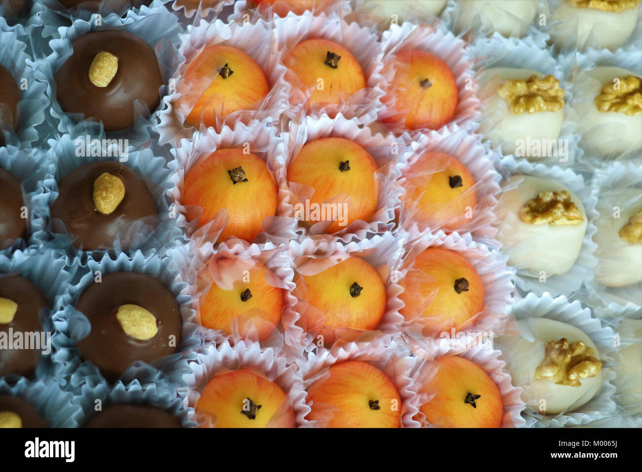 Beautiful candies made with chocolate, coconut, peanuts, pecan nuts and