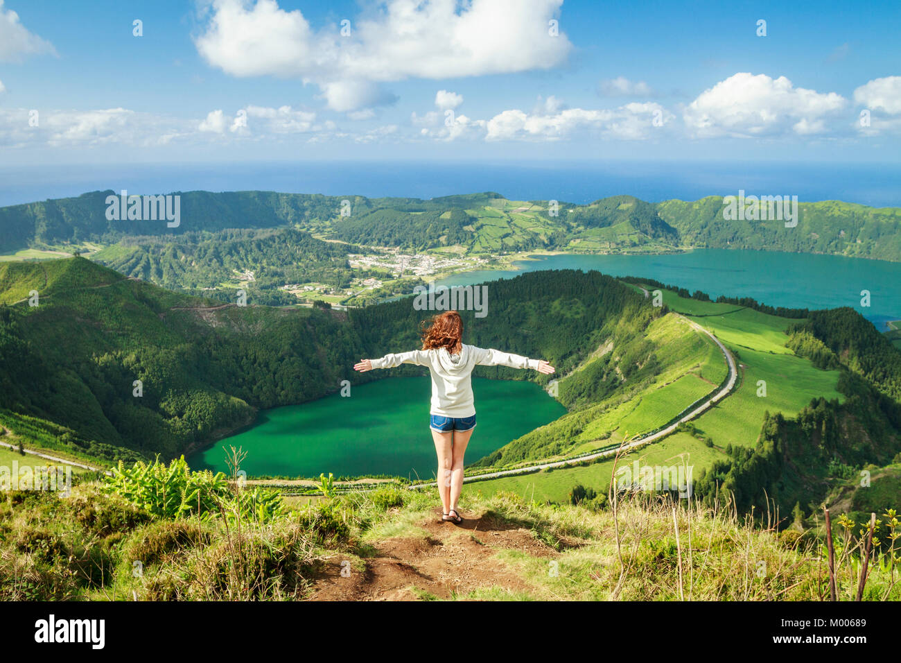 Young hiker female enjoying the Stunning view of Sete Cidades lakes from the viewpoint Miradouro Boca do Inferno,  Sao Miguel, Azores, Portugal Stock Photo