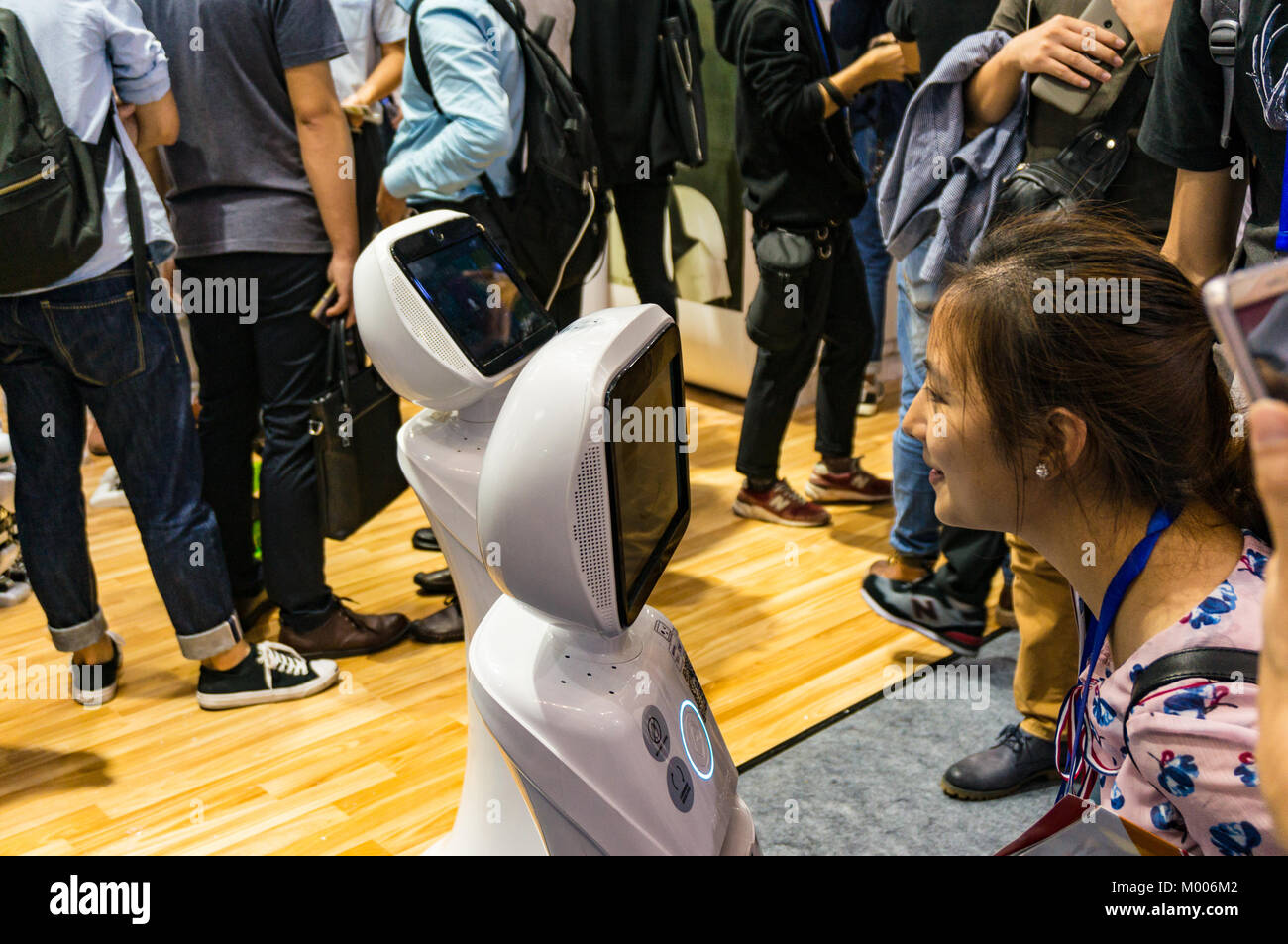 Robot interacting with woman at a technology fair in Shenzhen, China Stock Photo