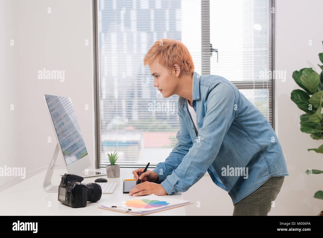 Photographer working at desk in modern office Stock Photo Alamy