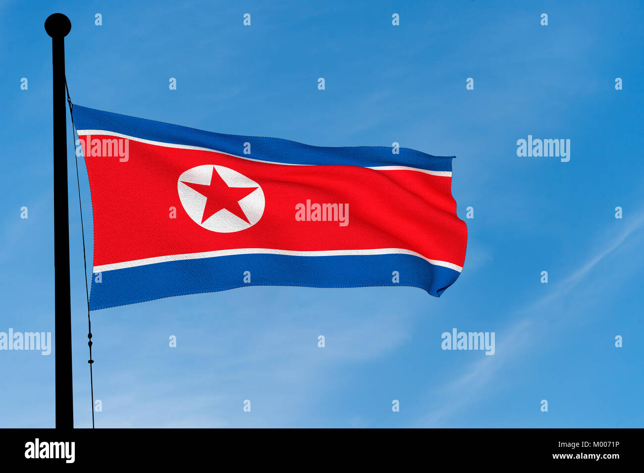 North Korean Flag waving over blue sky (3D rendering) Stock Photo