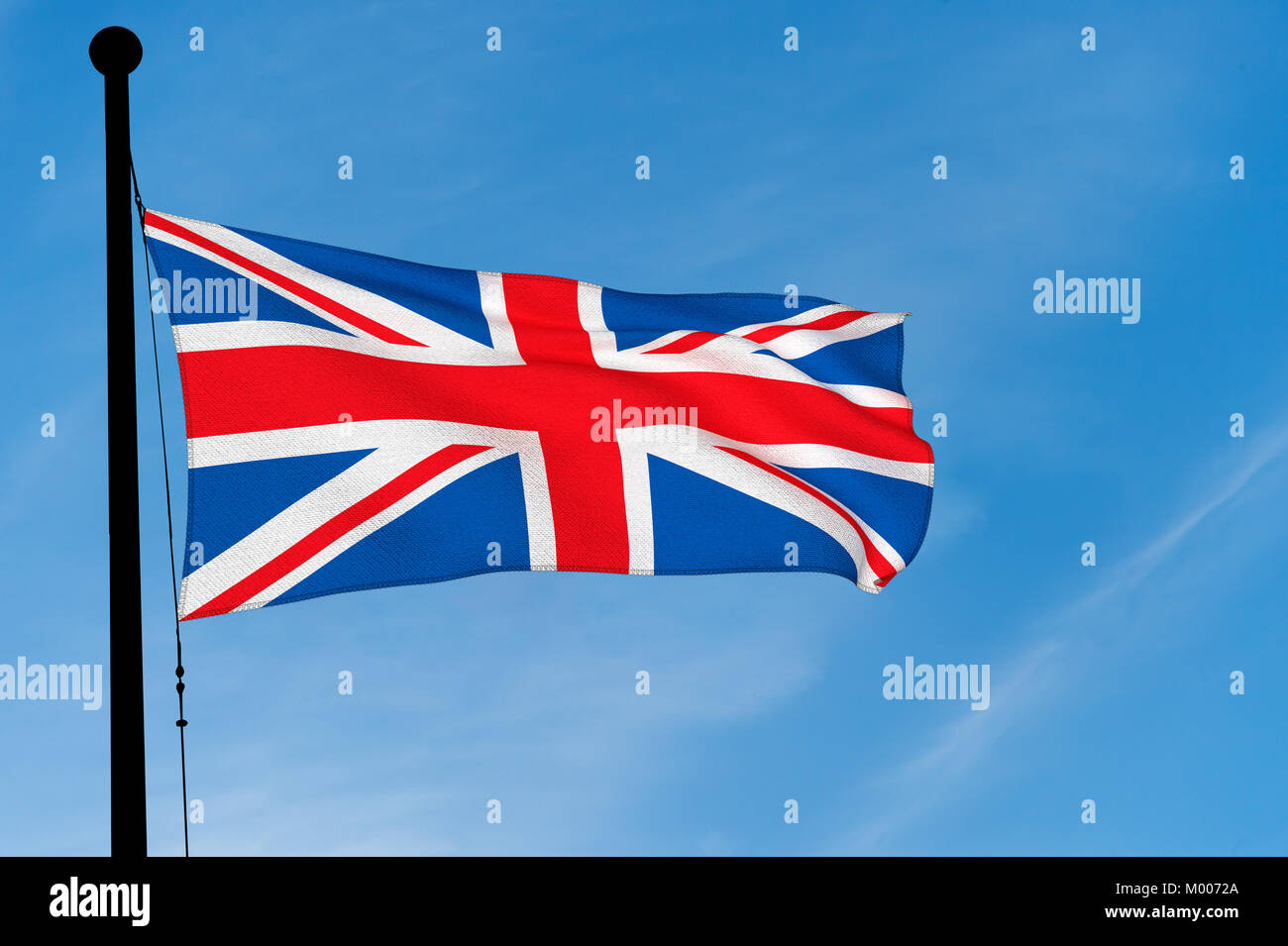 UK Flag waving over blue sky (3D rendering) Stock Photo