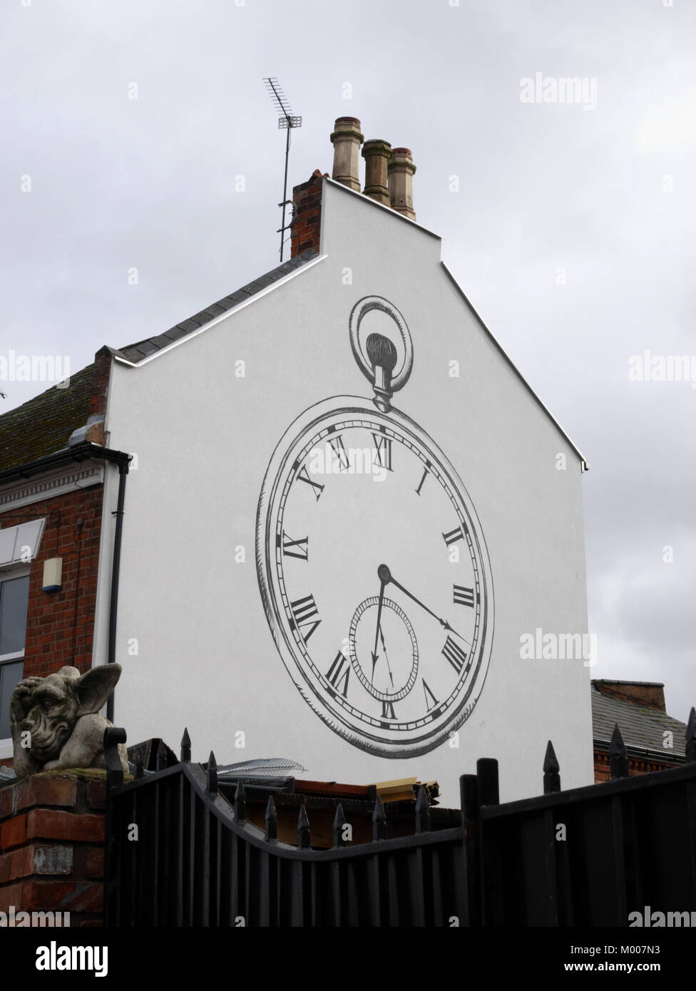 A pocket watch design on this end terrace in Craven Street, Coventry, commemorates the watchmaking history of the Chapelfields area of the city. Stock Photo