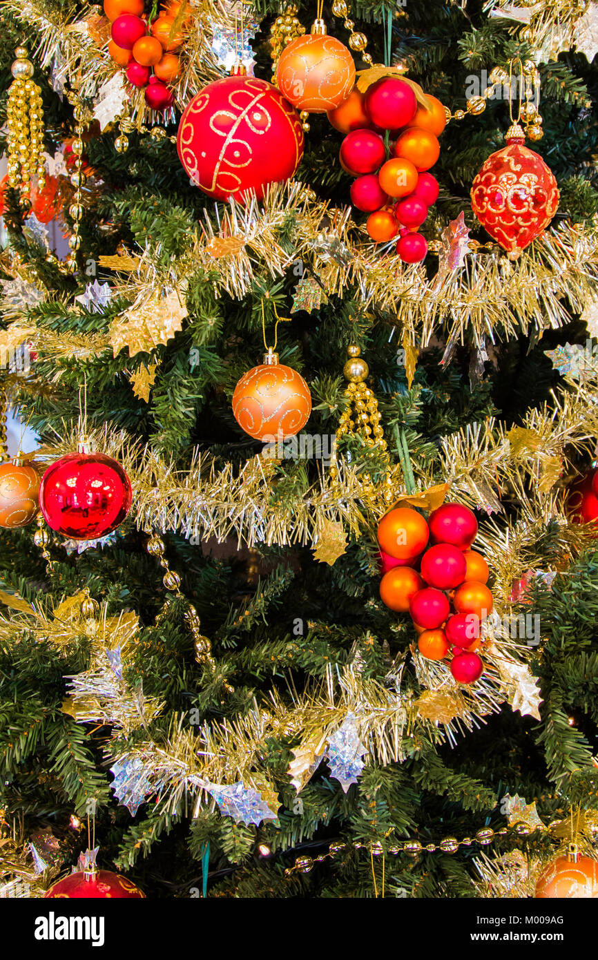 Close up of a christmas tree decorated with golden tinsel and gold ...