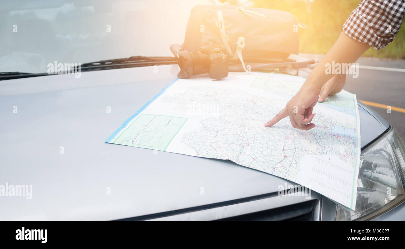 Hipster Asian woman backpacker look map on trip Stock Photo - Alamy