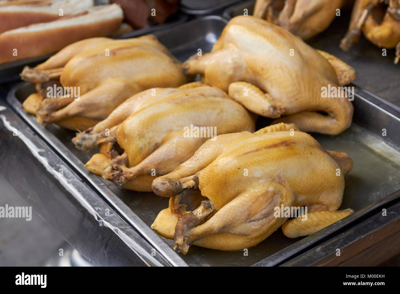 Whole, cooked chickens for sale at a Bangkok, Thailand street vendor