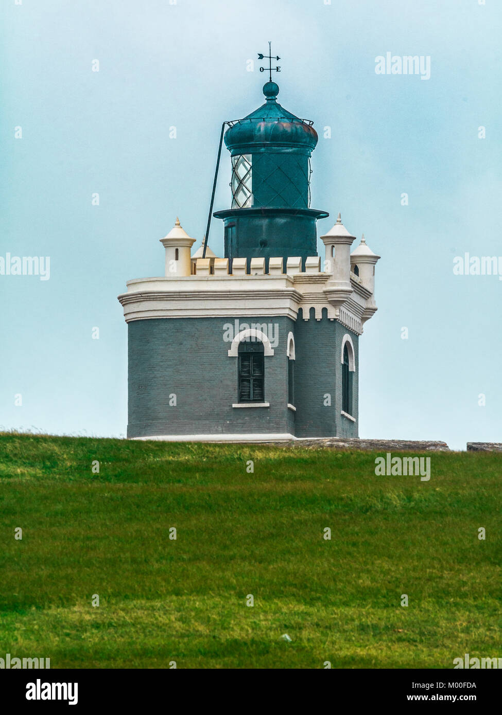 The lighthouse at El Morro fort from the field nearby in Old San Juan. Stock Photo