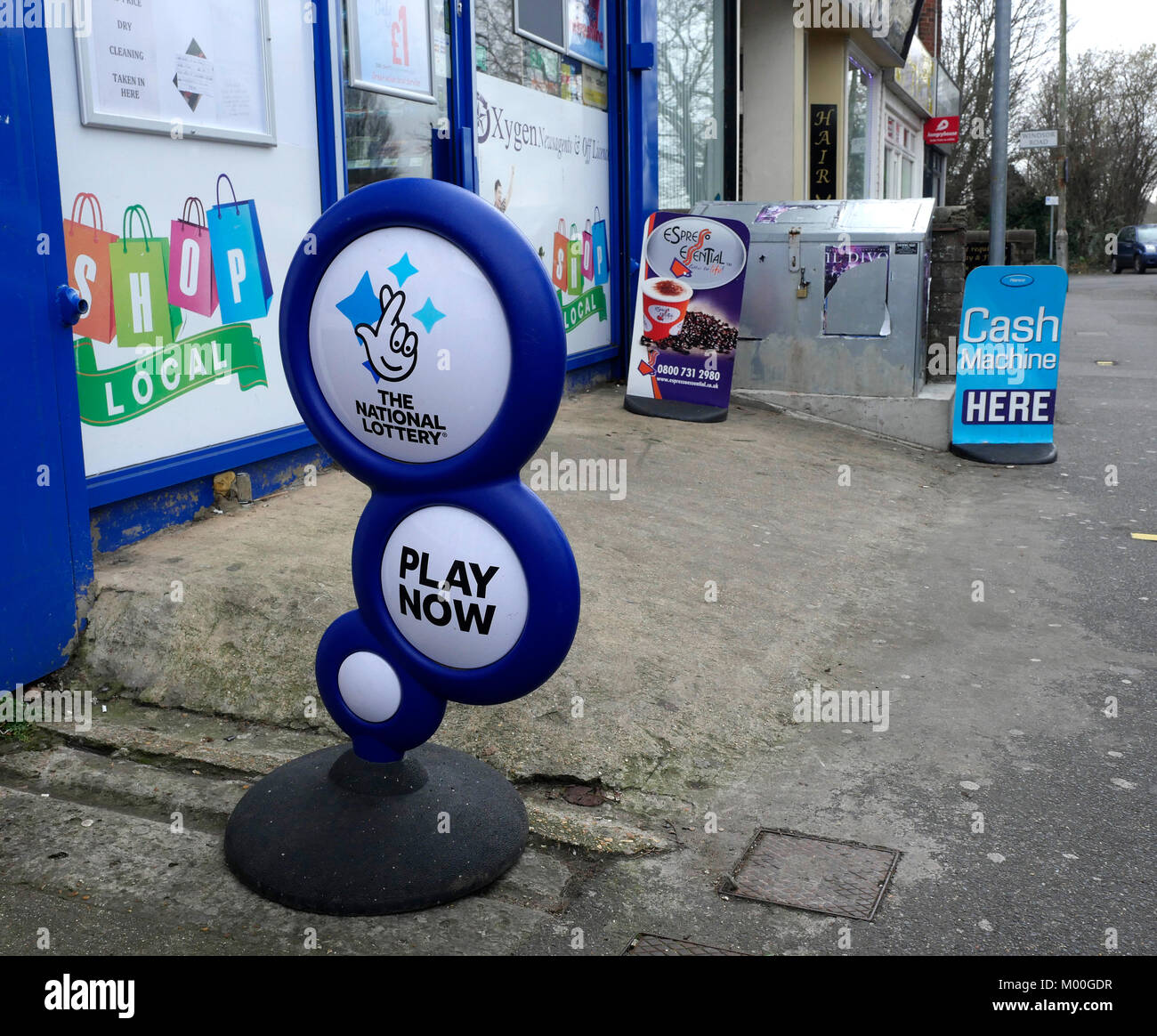 Advertising signs on pavement outside a newsagent in Portsmouth Road, Cosham, Hampshire, England