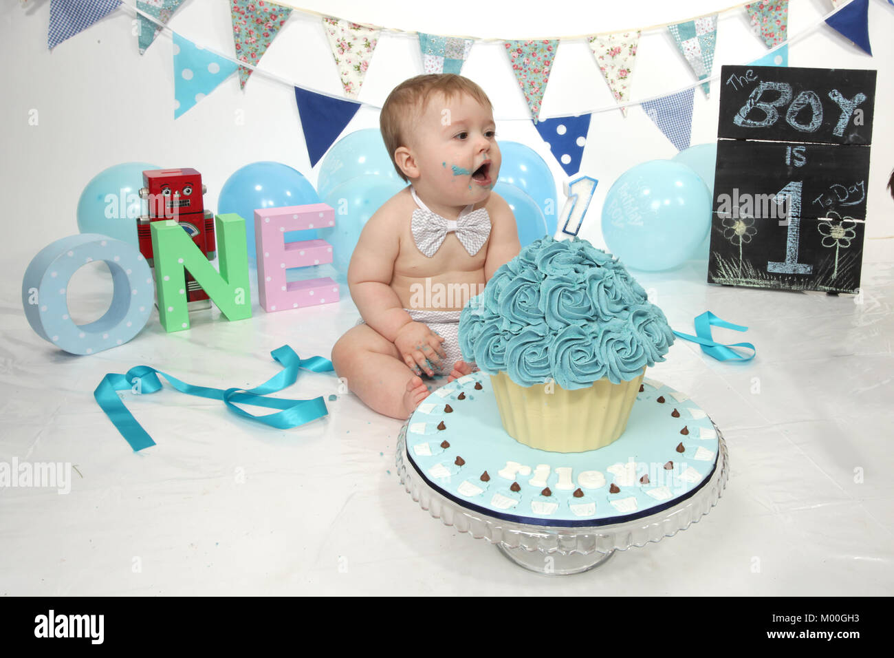 1 year old boy birthday party cake smash, fun food Stock Photo - Alamy