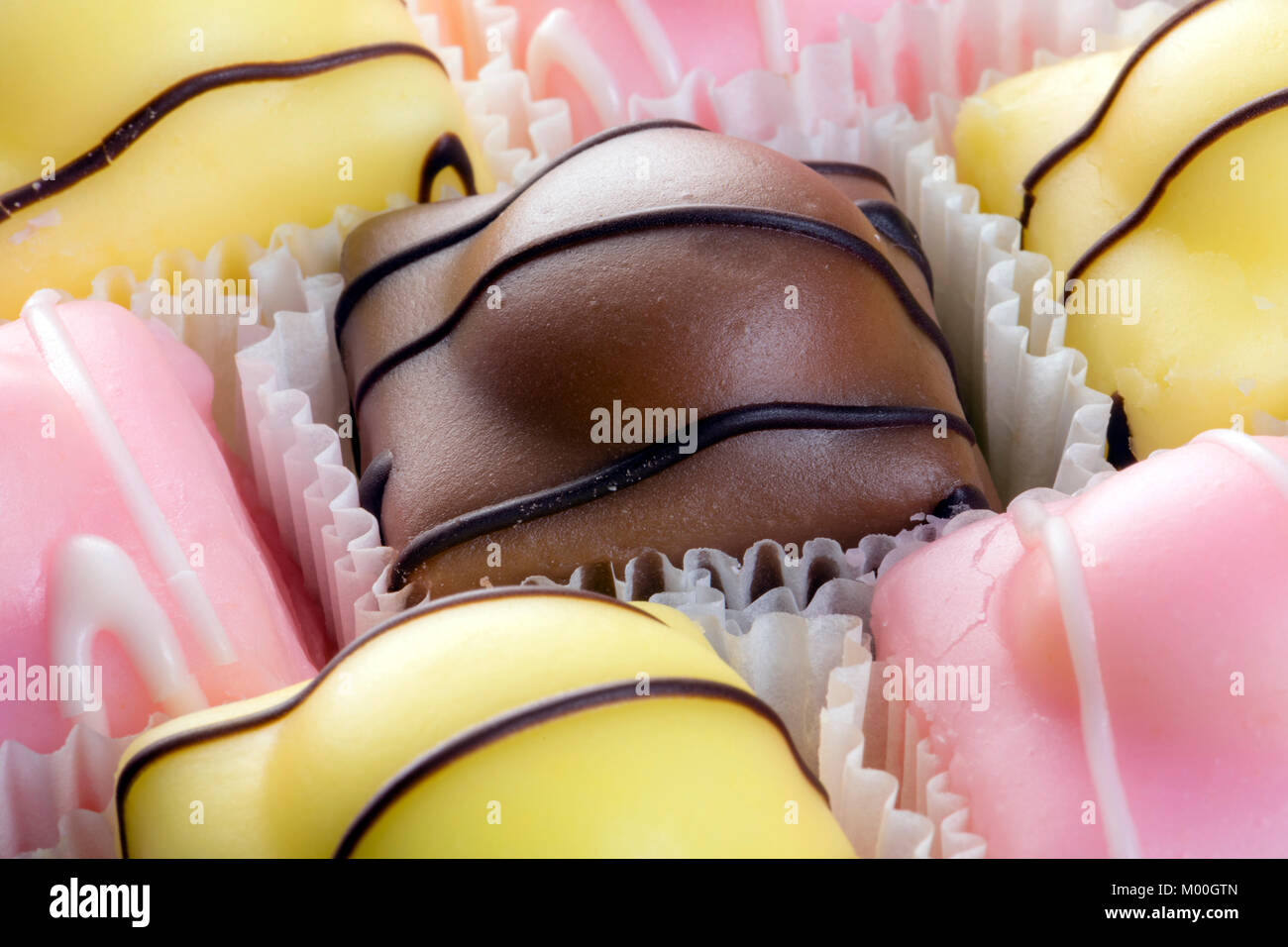 Fondant fancies cakes also known as French fancies. Stock Photo