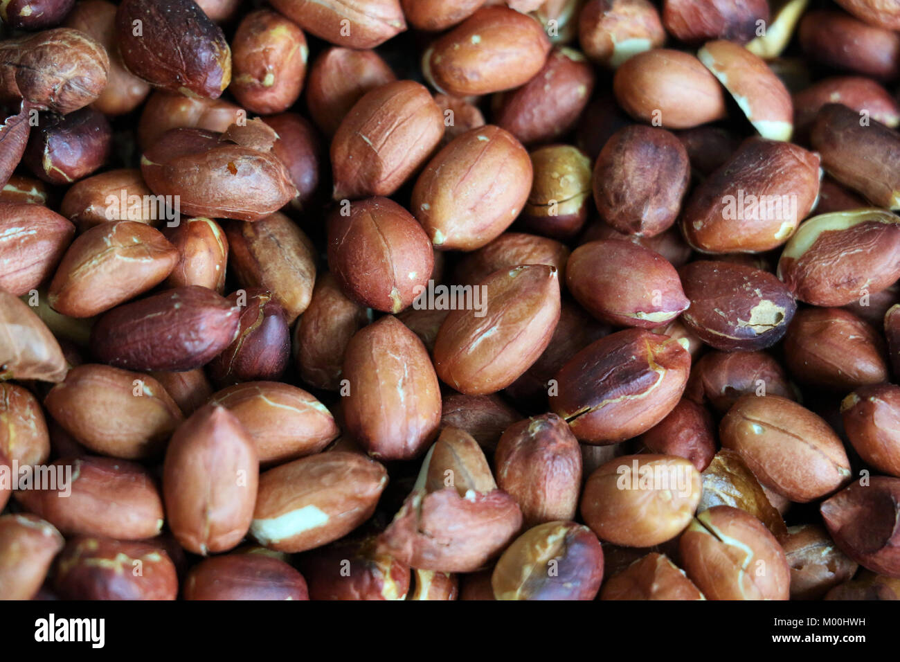 Red roasted peanuts, some open, with and without peel. Peanut