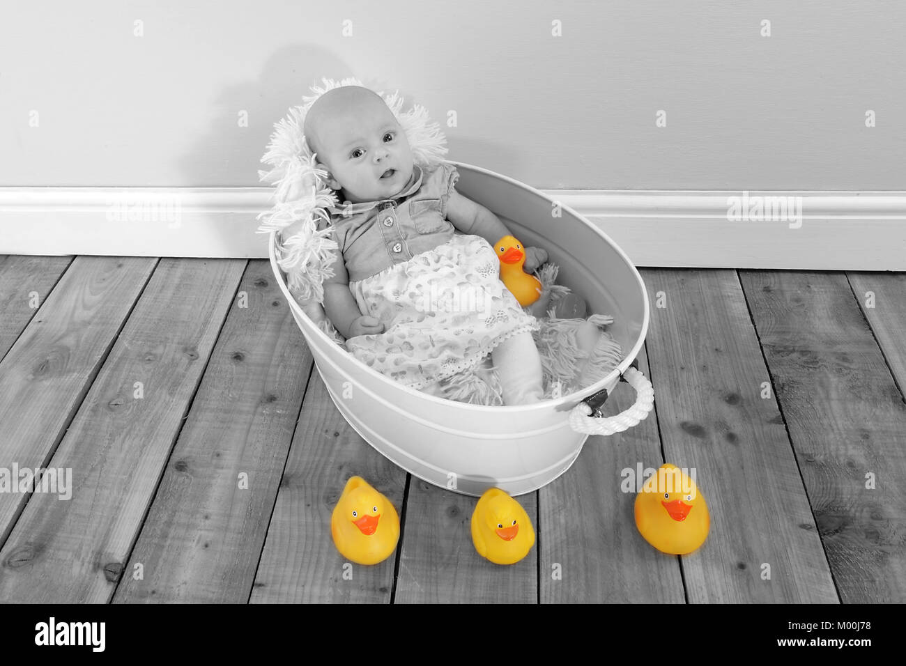 2 month old baby girl in bath tub with toy ducks, pretty little girl
