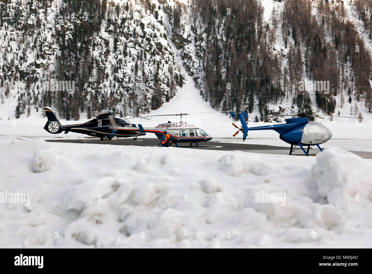 Three helicopters on a row in the airport of St Moritz Switzerland in the alps Stock Photo