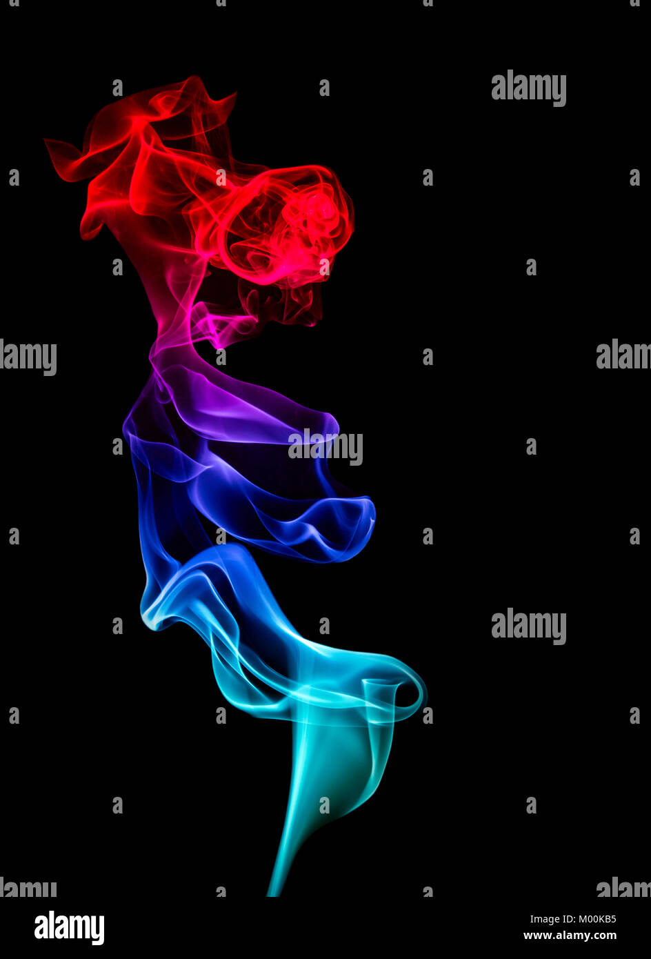 A vertical column of multi-coloured  smoke showing red blue and cyan hues, having both scientific and artistic appeal as well as black copy space Stock Photo