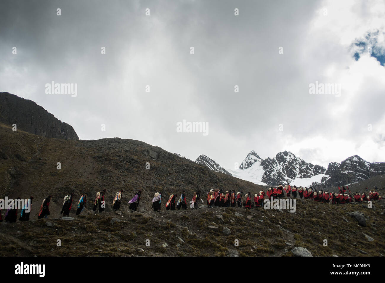 Cusco, Peru. 29th Dec, 2017. Members of the Paucartambo nation, ascend to Ausangate Mountain, at 6362m, carrying their cross to be blessed by the Lord of Qoyllur Riti.The pilgrimage includes processions with crosses that climb to the snowy summit of the mountain and then descend the next day.Quyllur Rit'i or Star Snow Festival is a spiritual and religious festival held Annually at the Sinakara Valley in the Cusco Region of Peru. Groups of Quero indigenous people climb Ausangate Mountain, at 6362m, in search of the Snow Star Which is reputedly buried Within the mountain.According to the Stock Photo