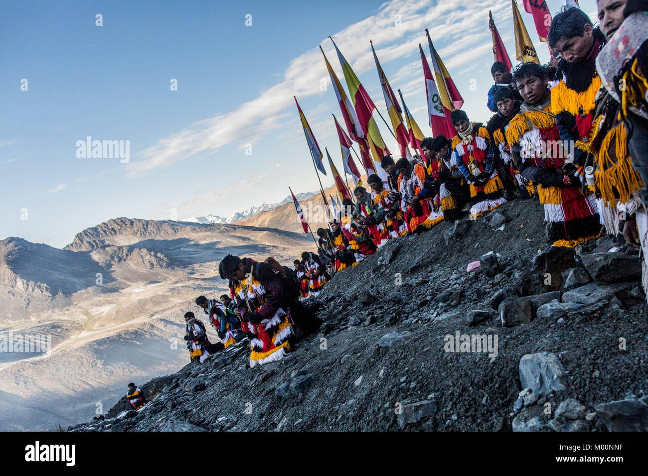 Cusco, Peru. 29th Dec, 2017. Members of the Nation Acomayo await the sunrise at Ausangate Mountain, at 6362m, the snow covered has been affected by the climate change, years ago this area is covered by snow.Quyllur Rit'i or Star Snow Festival is a spiritual and religious festival held Annually at the Sinakara Valley in the Cusco Region of Peru. Groups of Quero indigenous people climb Ausangate Mountain, at 6362m, in search of the Snow Star Which is reputedly buried Within the mountain.According to the chroniclers, the Qoyllur Rit'i is the Christ that the Church sent painted on a rock at Stock Photo