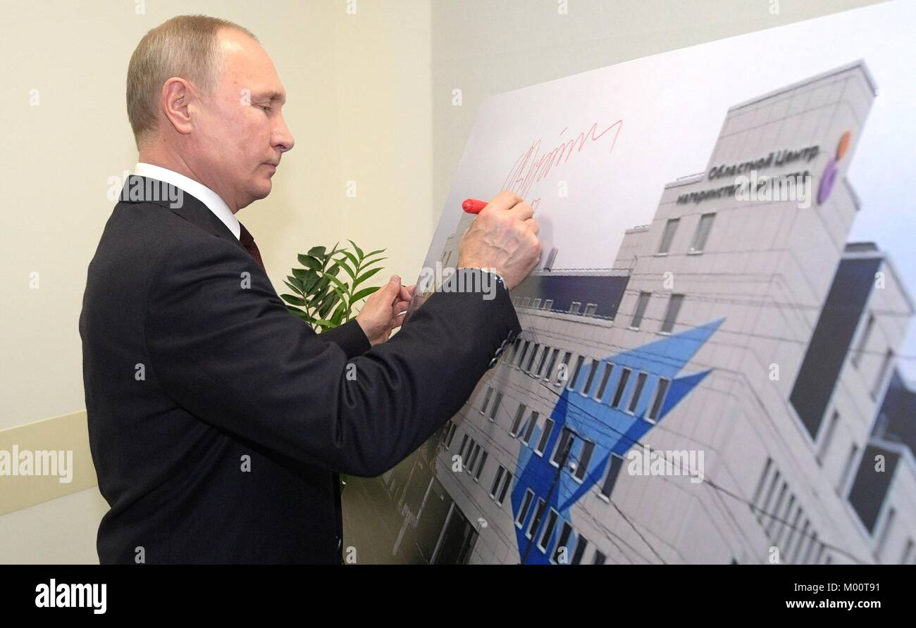 Kolomna, Russia. 17th Jan, 2018. Russian President Vladimir Putin autographs a poster after touring the Perinatal Center January 17, 2018 in Kolomna, Russia. Putin visited the historic town to encourage rural development while preserving the unique character of traditional towns. Credit: Planetpix/Alamy Live News Stock Photo