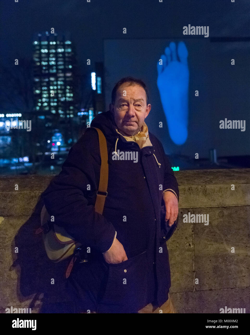 London, UK. 17th Jan 2018. Artist David Ward in front of his 'Light On Their Feet' installation at the Rambert Bulding. Ward's work shows photographs of the feet of the dancers from Ballet Rambert, projected onto the side of the world famous dance company’s new building. Lumiere London 2018 Lights festival. Lumiere London is a light festival that presents an array of public art work and light installations across the capital. Credit: Imageplotter News and Sports/Alamy Live News Stock Photo