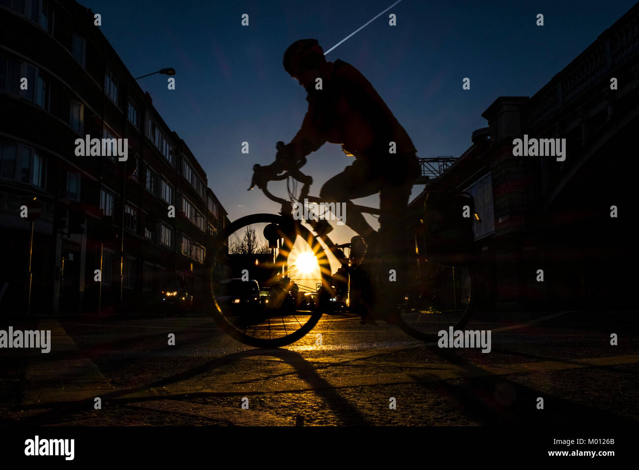 London, UK. 18th Jan, 2018. A cyclist speeds by on a calm and bright start to the day in London after the capital had been battered by high winds overnight (c) Credit: Paul Swinney/Alamy Live News Stock Photo