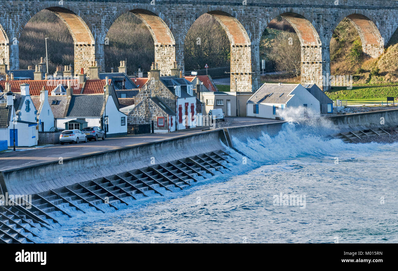 CULLEN MORAY SCOTLAND WAVES AND SPRAY NEAR HOUSES UNDER THE CULLEN