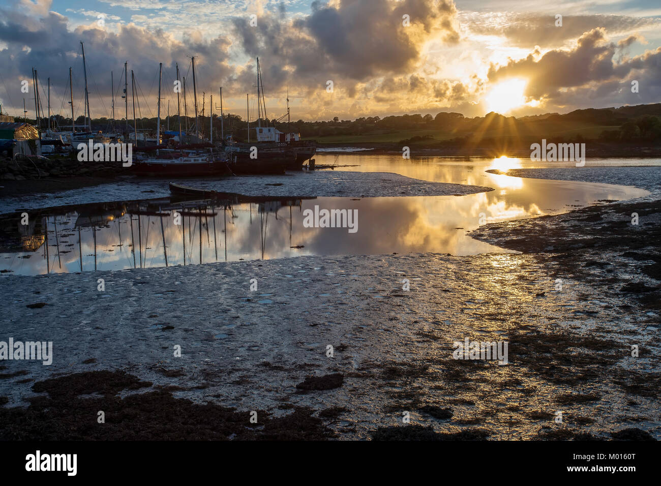 Sunset at the Boatyard in Baltimore Co Cork with beautiful reflections of the Sky in the meandering River. Stock Photo