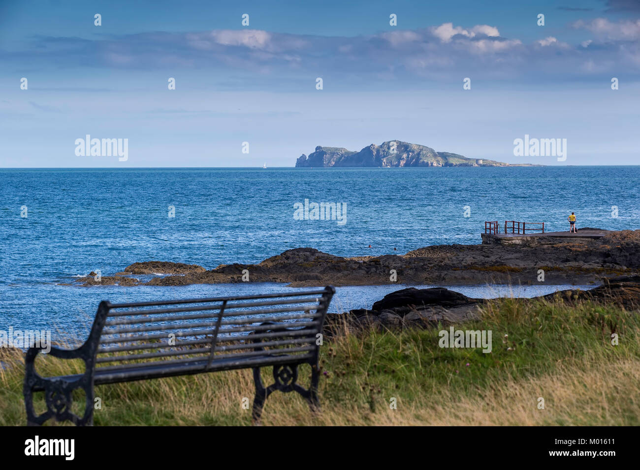 A Photo of some people swimming at the Low Rock in Malahide with Irelands Eye in the Background. Stock Photo