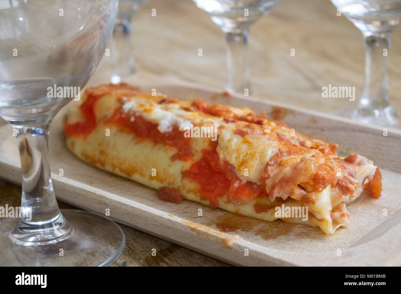 cannelloni filled with ground beef and covered with mozzarella and