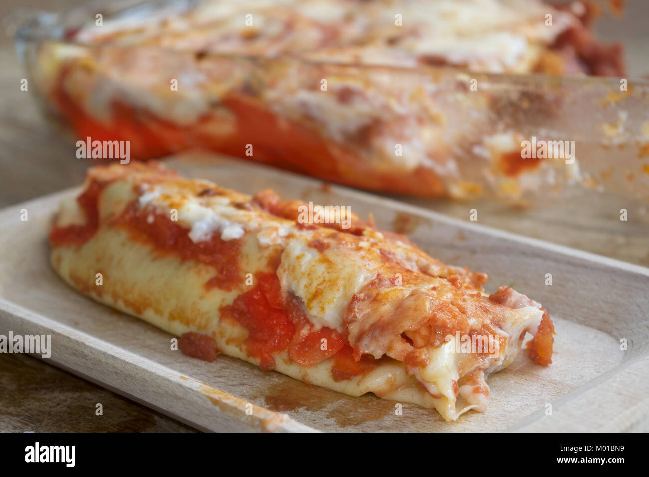 cannelloni filled with ground beef and covered with mozzarella and