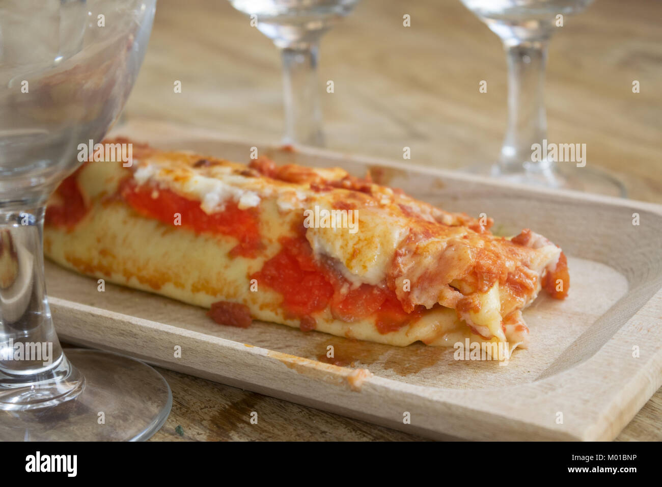cannelloni filled with ground beef and covered with mozzarella and