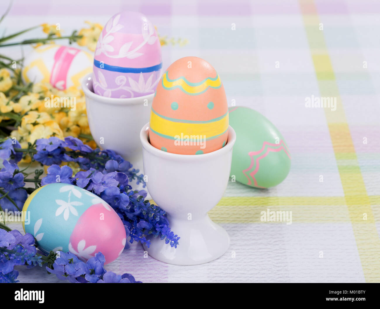 Decorative Easter Eggs And Egg Cups With Flowers Stock Photo