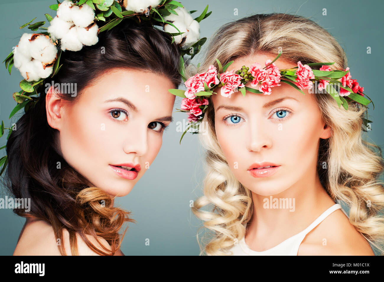 Beautiful Women with Permed Hairstyle, Makeup and Flowers. Young Beauty Stock Photo